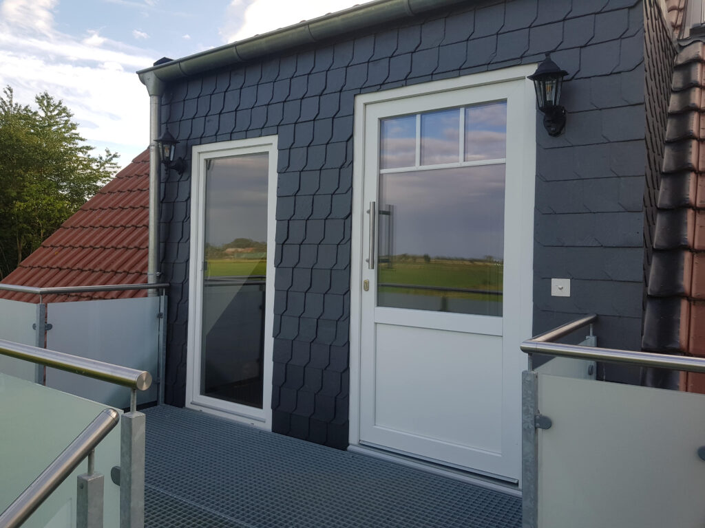 Terrace with barbecue and green views at the Canhusen holiday apartment