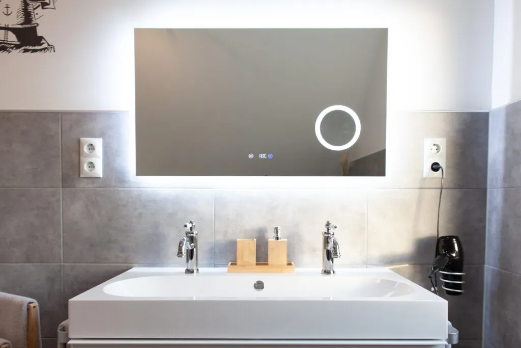 Modernes Badezimmer der Ferienwohnung Canhusen mit großer Dusche, Waschmaschine und Trockner